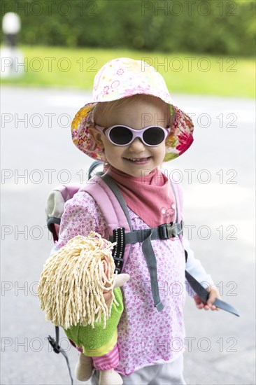 Toddler hiking with doll