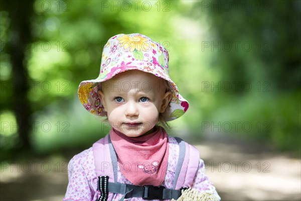 Toddler hiking through the woods