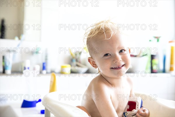 Toddler bathing in a bathtub for children