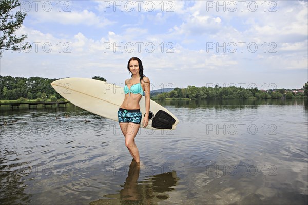 Young woman with a surfing board