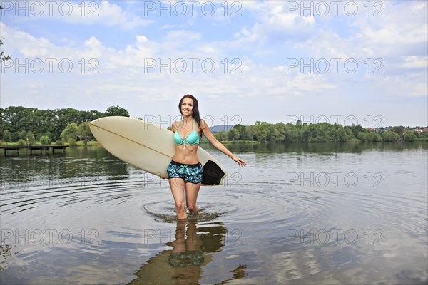 Young woman with a surfing board