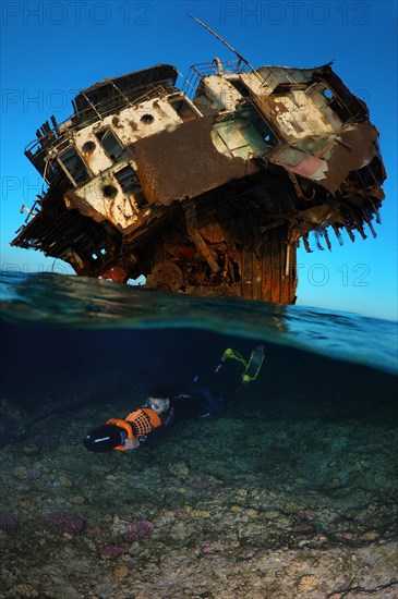 Freediver swimming with an underwater scooter