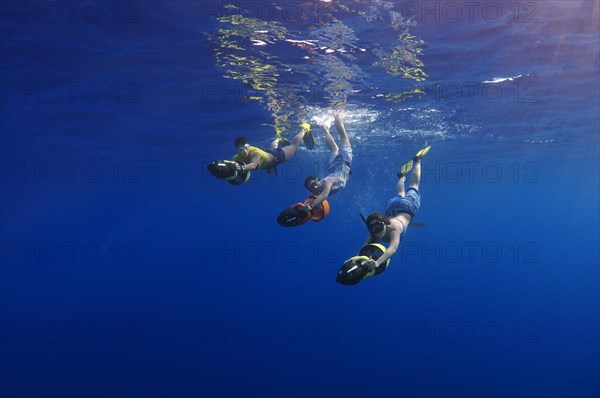 Freedivers with underwater scooters