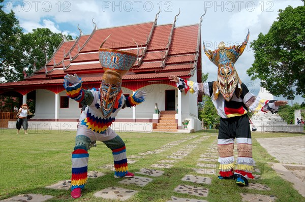 People dressed up with ghost masks and colourful costumes