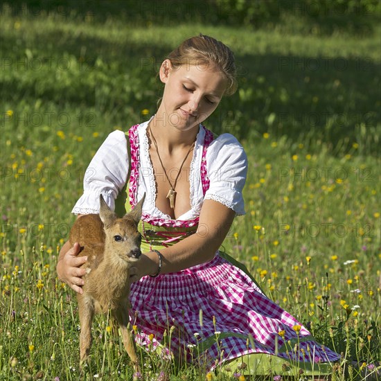 Young woman with a European roe deer