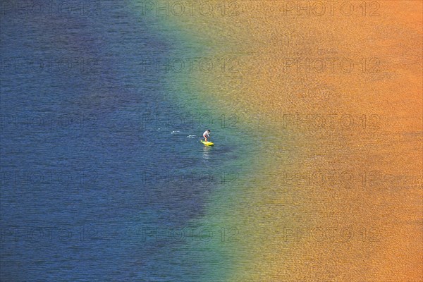 Person with standing paddle in the water