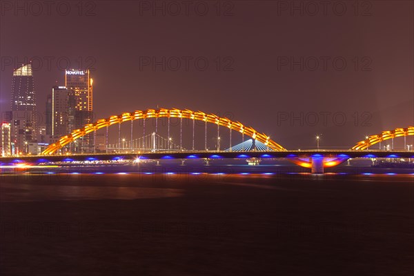 Illuminated Cáº§u Rá»“ng or dragon bridge over the Han River at night