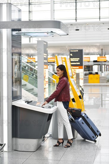 Woman with luggage at the InfoGate