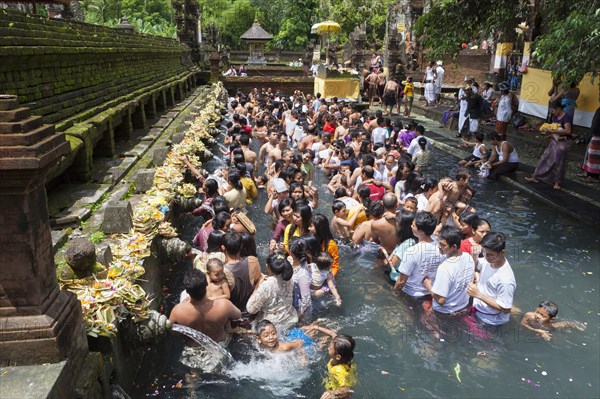 People at the sacred spring of Tirta Empul during Kuningan festival