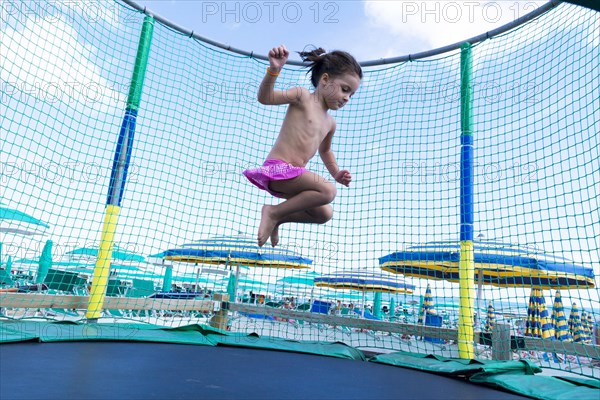 Kid jumping on a trampoline