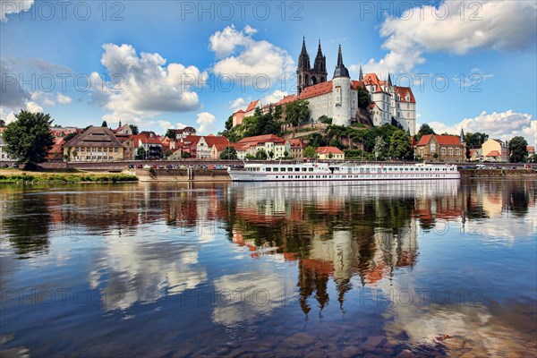 Castle hill with Albrechtsburg and Cathedral reflected in the water of the Elbe