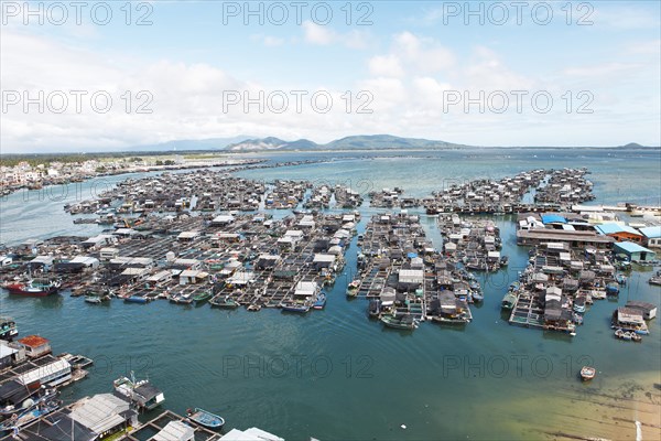 Fishing boats and fish farms in the sea by Monkey Island