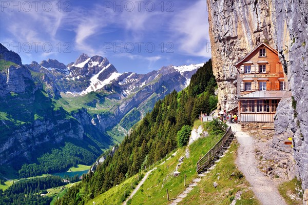 Mountain restaurant Aescher overlooking lake Seealpsee and Altmann mountain