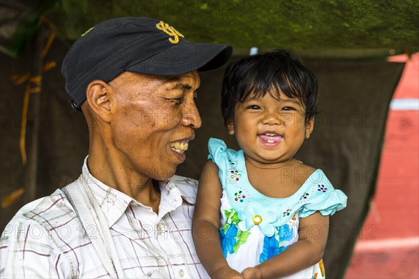 Smiling man with child