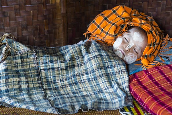 Sleeping child with Thanaka paste on the face