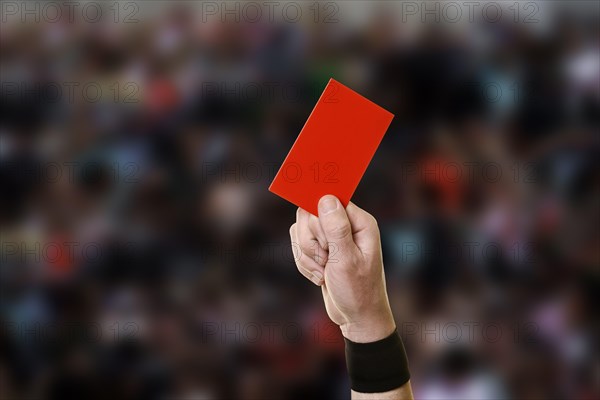 Referee showing a red card during a football game