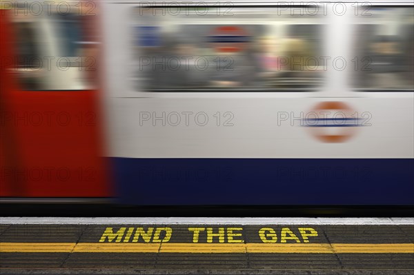 Mind the Gap warning sign on the platform edge of a London underground station