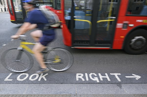 Look Right painted onto the tarmac of a busy road crossing point