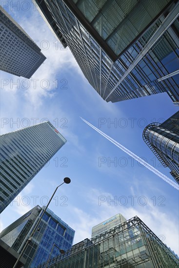 Airplane flying over skyscrapers