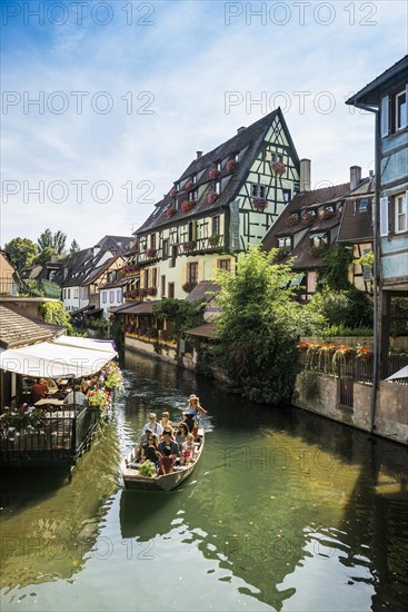 Timbered houses and canal with excursion boat