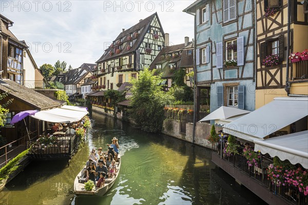 Timbered houses and canal with excursion boat