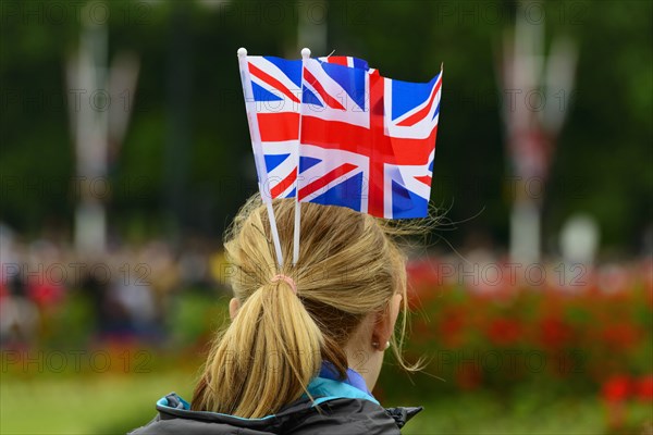 Female fan of the Queen with Union Jack flags on her head