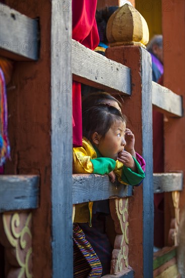Children watching the happenings of a temple festival at Jakar Dzong