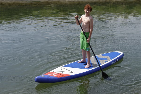 Boy on a stand up board