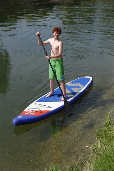 Boy on a stand up board