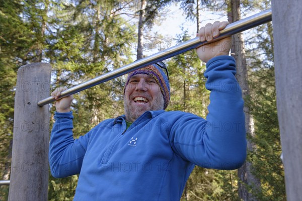 Man doing pull-ups on a bar