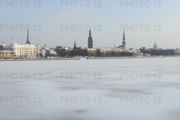 Historical centre on the banks of the frozen Daugava river with Riga Cathedral