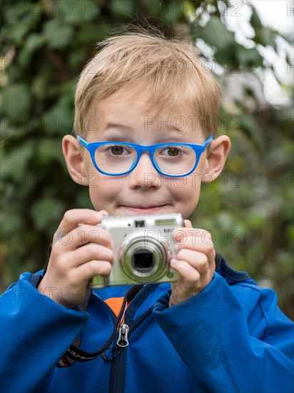 Boy with compact camera