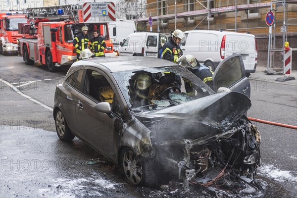 Fire department extinguishing a burning Corsa