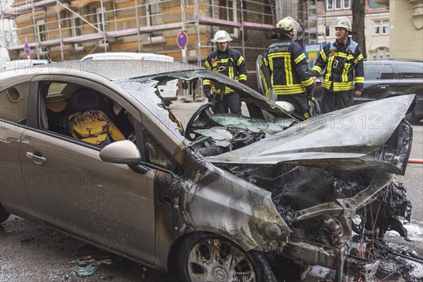 Fire department extinguishing a burning Corsa