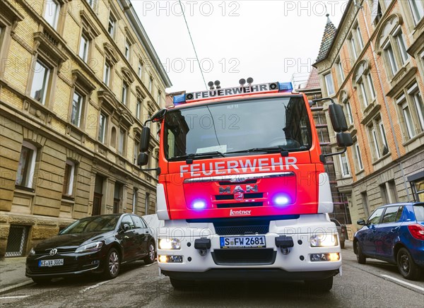 Firemen with blinking lights in a street
