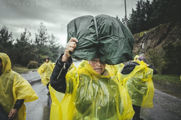 Incoming refugees in rain