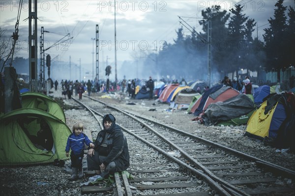 Camp with refugees on the train tracks