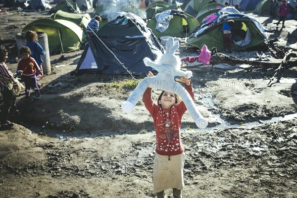 Child playing with stuffed toy