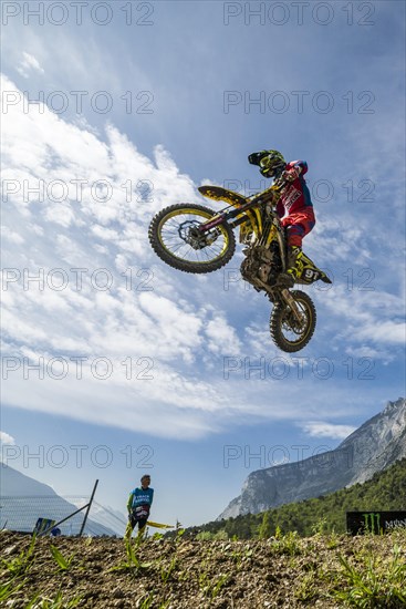 Motorcyclist on a motocross bike jumping through the air