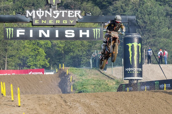 Motorcyclist on a motocross bike jumping through the air