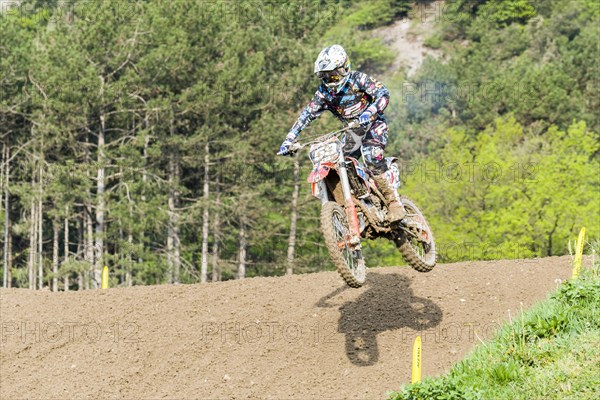 Motorcyclist on a motocross bike jumping through the air