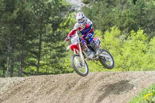 Motorcyclist on a motocross bike jumping through the air