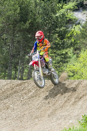 Motorcyclist on a motocross bike jumping through the air