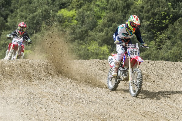 Two motorcyclists on motocross bikes