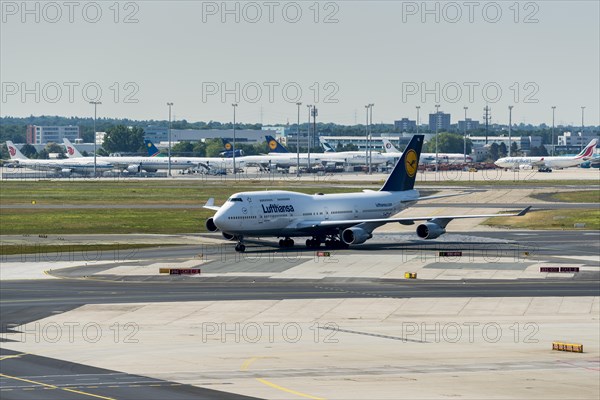 A Boeing 747 of the airline Lufthansa is moving on the ground of Frankfurt International Airport