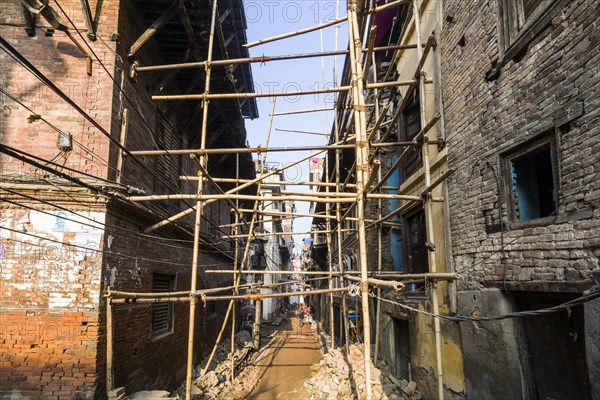 Damaged houses are stabilized by bamboo poles after the 2015 earthquake