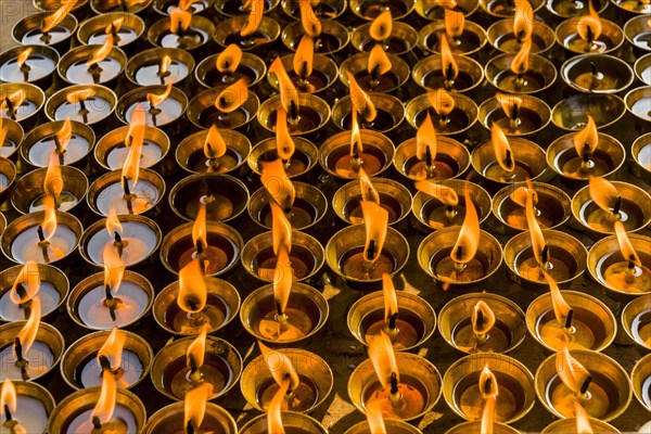 Many butter lamps are lightened at a temple in Boudha