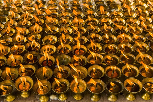 Many butter lamps are lightened at a temple in Boudha
