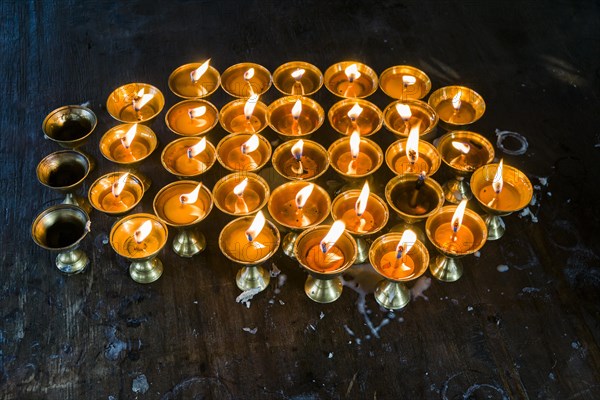 Many butter lamps are lightened at a temple in Boudha