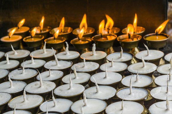 Many butter lamps are lightened at a temple in Boudha